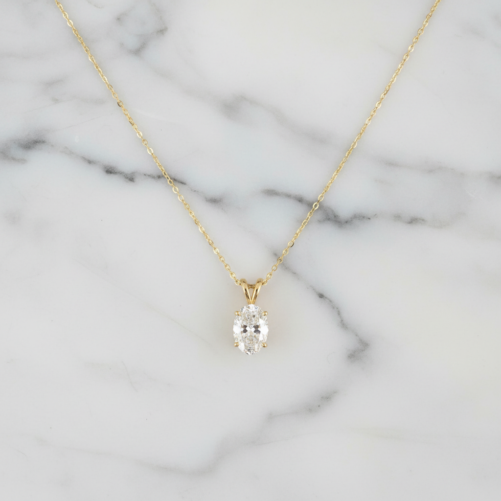 Oval diamond pendant on marble with worn perspective