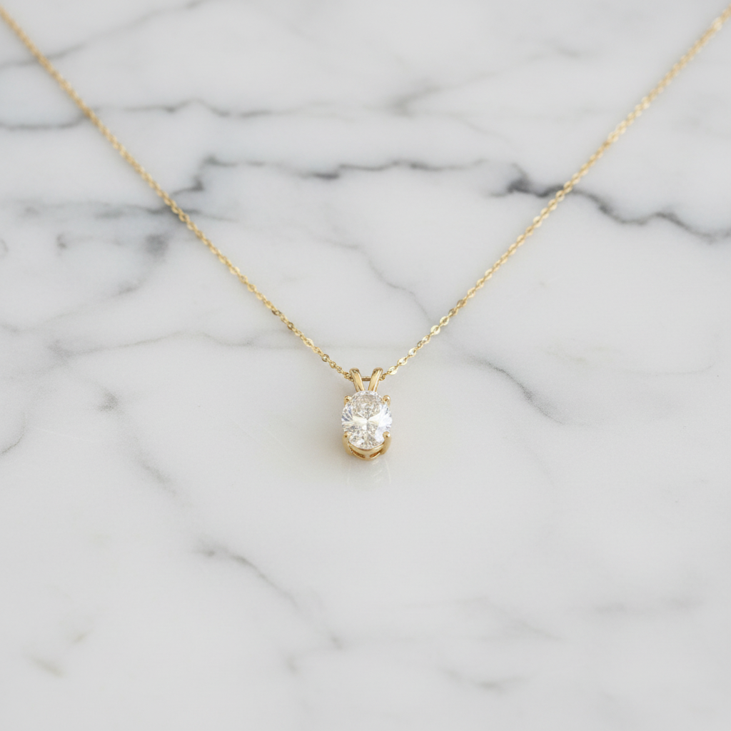 Oval diamond pendant on marble